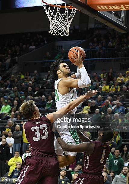 University of Oregon junior forward Dillon Brooks shoots over University of Montana redshirt-freshman Jared Samuelson during a non-conference NCAA...