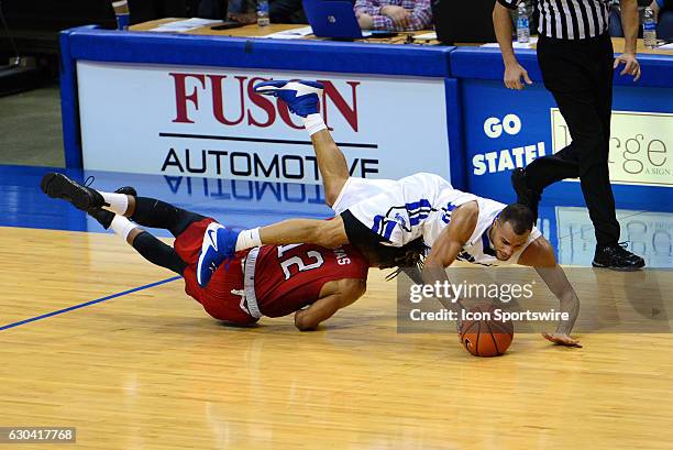 Indiana State Sycamores Guard Brenton Scott dives over Western Kentucky Hilltoppers Guard Pancake Thomas after a loose ball during the game on...