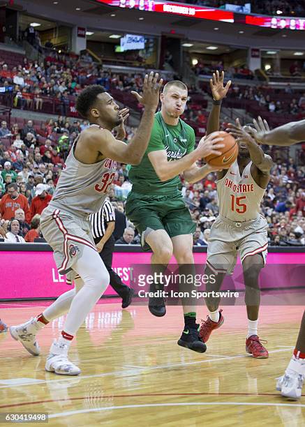 Marshall Thundering Herd guard Stevie Browning dribbles the ball between Ohio State Buckeyes center Trevor Thompson and Ohio State Buckeyes guard Kam...