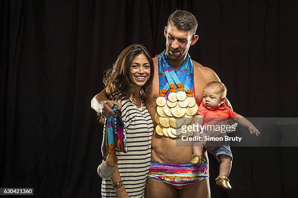 Olympic swimmer Michael Phelps is photographed with his wife, Nicole Johnson and son Boomer, for Sports Illustrated with his Olympic medals, 28 in...