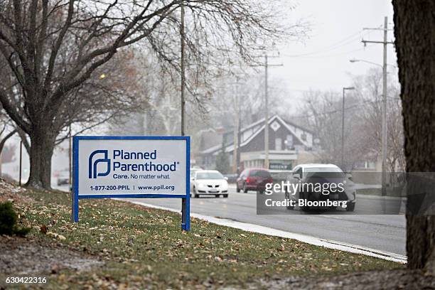 Vehicles drive past signage in front of a Planned Parenthood office in Peoria, Illinois, U.S., on Friday, Dec. 16, 2016. Republicans are thinking...