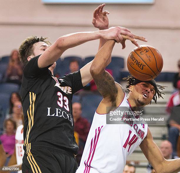 Erie Bay Hawks center Stephen Zimmerman and Maine Red Claws guard Damion Lee fight for a rebound during D League action at the Portland Expo in...