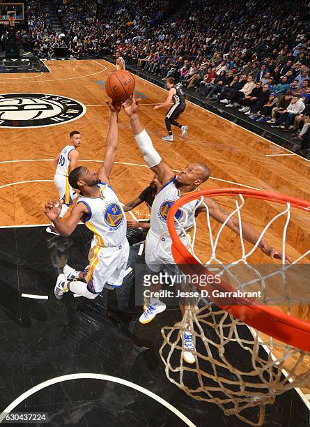 David West and Ian Clark of the Golden State Warriors grab the rebound against the Brooklyn Nets on December 22,2016 at Barclays Center in Brooklyn,...