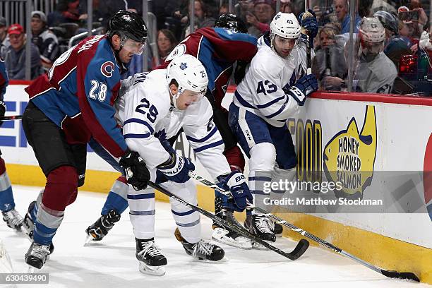 Patrick Wiercioch of the Colorado Avalanche and James van Riemsdyk of the Toronto Maple Leafs fight for control of the puck at the Pepsi Center on...