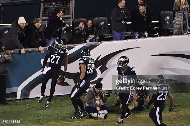 Malcolm Jenkins is celebrated by Jordan Hicks, Jaylen Watkins and Rodney McLeod, all of the Philadelphia Eagles, after a first quarter touchdown...
