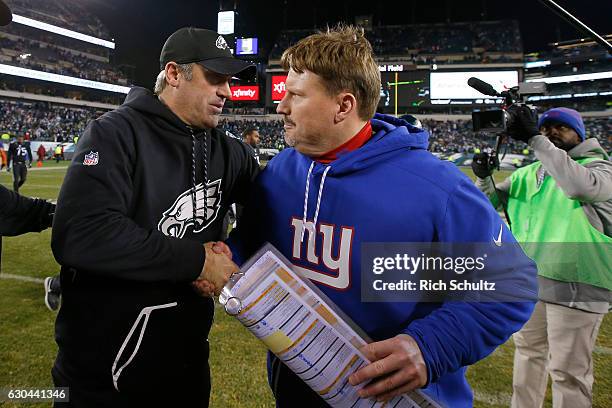 Head coach Doug Pederson of the Philadelphia Eagles shakes hands with head coach Ben McAdoo of the New York Giants after their game at Lincoln...