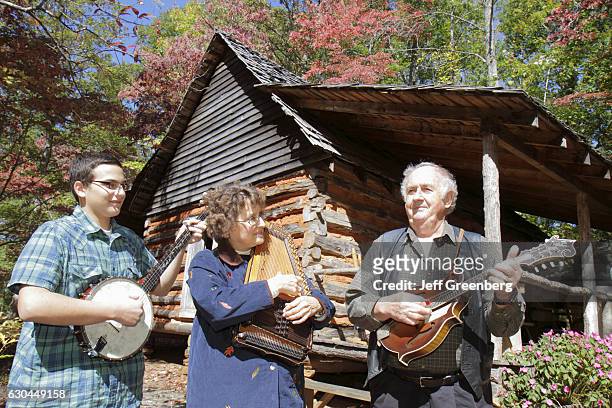 Man, woman and teen boy playing traditional instruments at Georgia Mountain Fairgrounds.