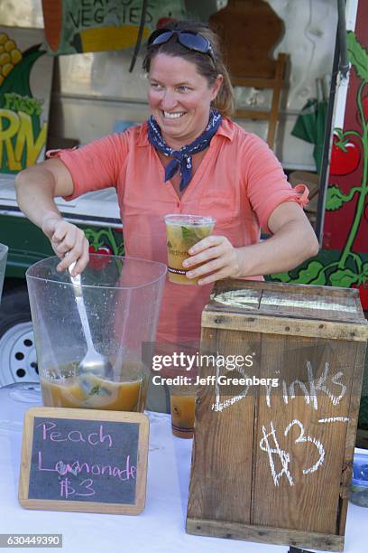 Woman selling peach lemonade at a farmers market in Plimoth Plantation.