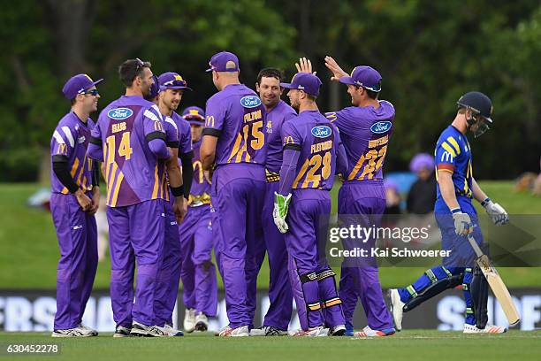 Ben Hilfenhaus of the Kings is congratulated by team mates after dismissing James Neesham of the Volts during the McDonalds Super Smash T20 match...