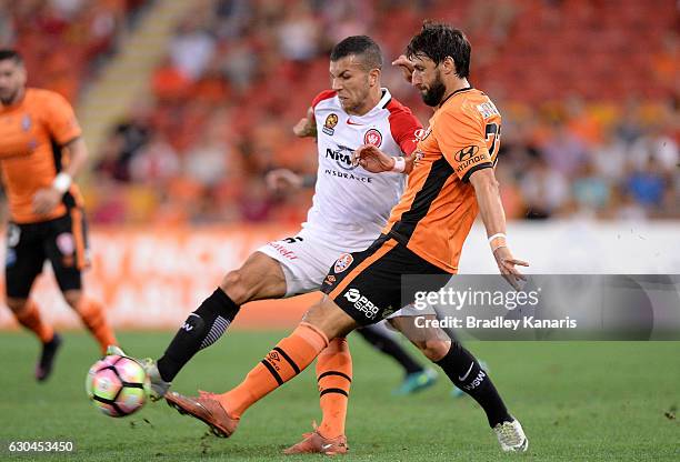 Thomas Broich of the Roar is pressured by the defence during the round 22 A-League match between Brisbane Roar and Western Sydney Wanderers at...