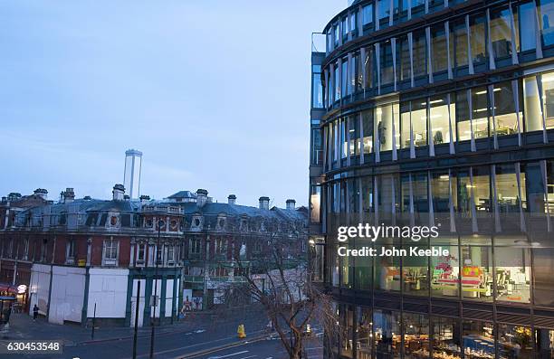 Father Christmas in his sleigh being pulled by Rudolph the Red Nose Reindeer is created from Post-it notes and displayed on an office window in...