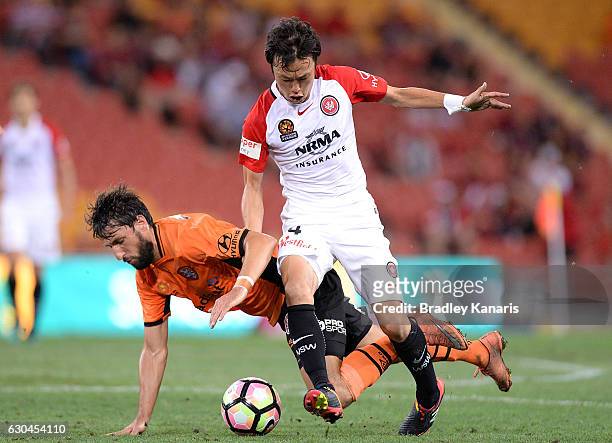 Jumpei Kusukami of the Wanderer is challenged by Thomas Broich of the Roar during the round 22 A-League match between Brisbane Roar and Western...
