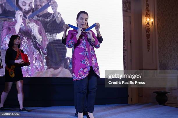 Chairman Felipe M. De Leon Jr. Wears the medal around Senator Loren Legarda. The National Commission for Culture and the Arts is awarding the "Dangal...