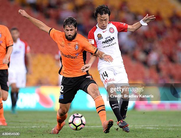 Thomas Broich of the Roar and Jumpei Kusukami of the Wanderers challenge for the ball during the round 22 A-League match between Brisbane Roar and...