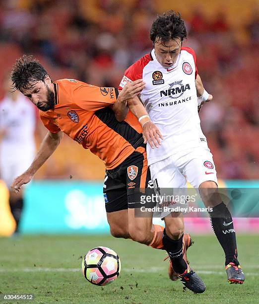 Thomas Broich of the Roar and Jumpei Kusukami of the Wanderers challenge for the ball during the round 22 A-League match between Brisbane Roar and...