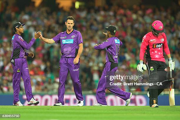 Shaun Tait of the Hurricanes celebrates with team mates after taking the wicket of Sam Billings of the Sixers during the Big Bash League match...