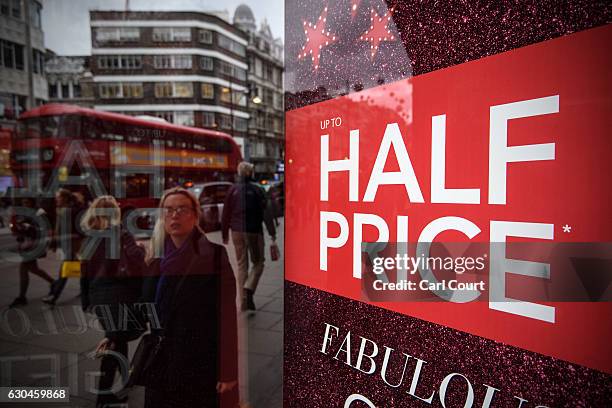 Sale sign is displayed in a store on Oxford Street on December 23, 2016 in London, England. Shoppers are continuing to spend as stores offer bargains...