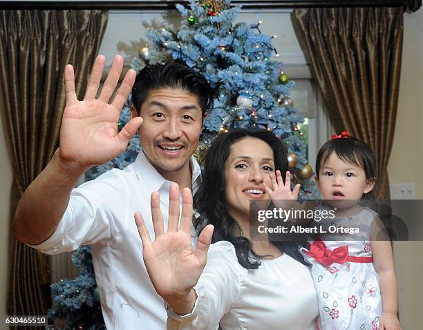 Actor Brian Tee of NBC's "Chicago Med", wife/actree Mirelly Taylor and daughter Madeline Skyer Tee give the high five in front of the Christmas Tree...