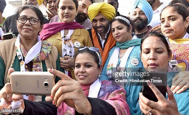 Women workers clicking selfie with AAP leader Bhagwant Mann after campaigning for Himmat Singh Shergill, AAP candidate from Majitha, during a...