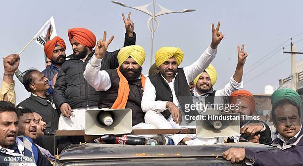 Leader Bhagwant Mann along with Himmat Singh Shergill, AAP candidate from Majitha, in a roadshow after addressing the public rally at village...