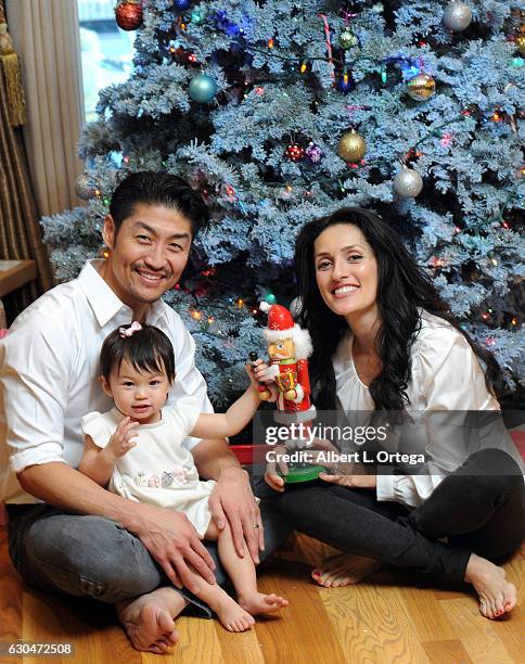 Actor Brian Tee of NBC's "Chicago Med", wife/actress Mirelly Taylor and daughter Madeline Skyer Tee pose in front of the Christmas Tree on December...