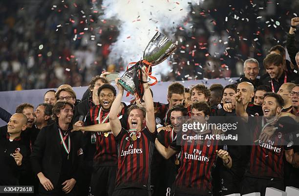 Milan team celebrating with Trophy after winning the Supercoppa TIM Doha 2016 match between Juventus FC and AC Milan at the Jassim Bin Hamad Stadium...