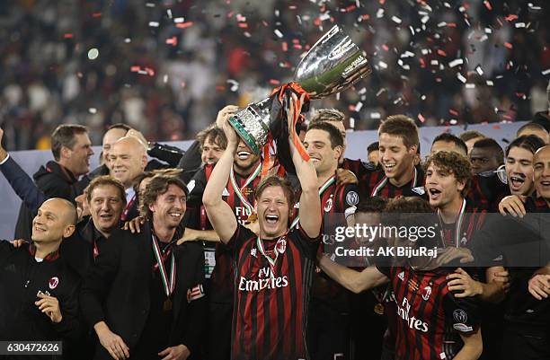 Milan team celebrating with Trophy after winning the Supercoppa TIM Doha 2016 match between Juventus FC and AC Milan at the Jassim Bin Hamad Stadium...