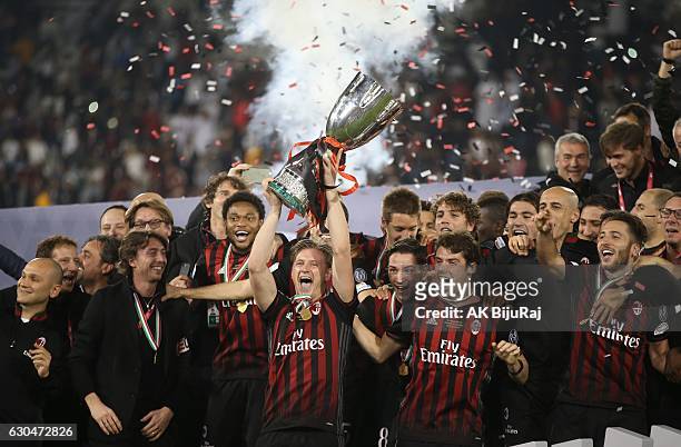 Milan team celebrating with Trophy after winning the Supercoppa TIM Doha 2016 match between Juventus FC and AC Milan at the Jassim Bin Hamad Stadium...