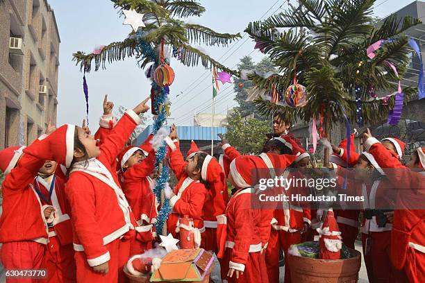 Children dressed as Santa Claus celebrate Christmas at Vidya Bal Bhawan Public School, Vasundhara on December 23, 2016 in Ghaziabad, India. With...