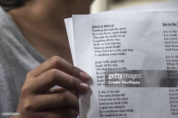 Child show a song lyric during preparation Christmas in Church Saint Antonius, Yogyakarta, Indonesia on December 23, 2016. This activities...