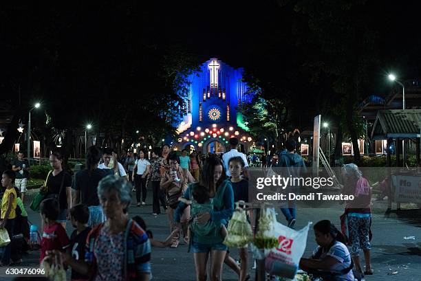 People walk outside a church after mass on December 23, 2016 in Manila, Philippines. Philippine president Rodrigo Duterte has said he wanted the...