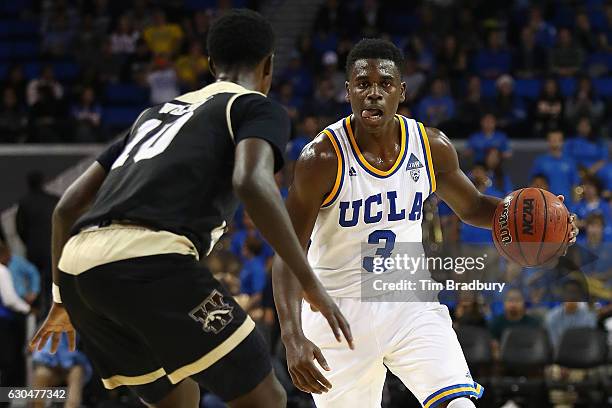 Aaron Holiday of the UCLA Bruins handles the ball against Thomas Wilder of the Western Michigan Broncos during their game at Pauley Pavilion on...