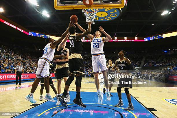 Leaf of the UCLA Bruins battles for a rebound with Seth Dugan and Adida Ikongshul of the Western Michigan Broncos during their game at Pauley...