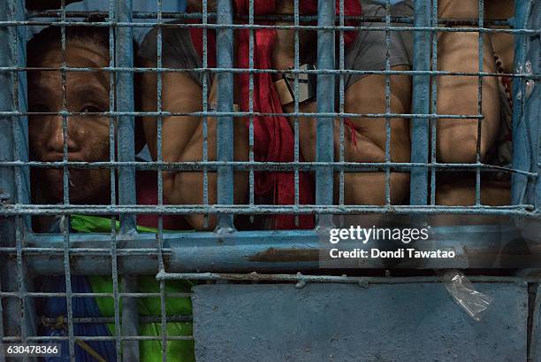 Female inmate looks outside an overcrowded police jail cell on December 15, 2016 in Manila, Philippines. Philippine president Rodrigo Duterte has...