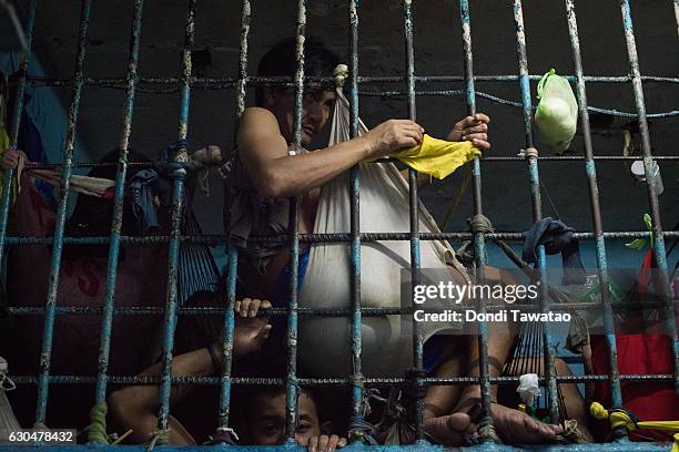 An inmate hangs in his hammock inside an overcrowded police precint jail cell December 15, 2016 in Manila, Philippines. Philippine president Rodrigo...