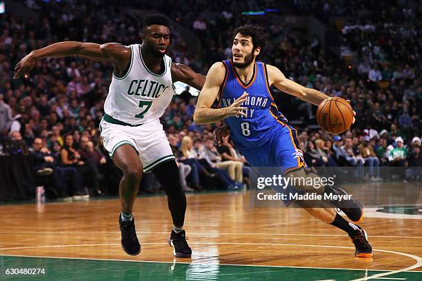 Alex Abrines of the Oklahoma City Thunder drives against Jaylen Brown of the Boston Celtics during the first half at TD Garden on December 23, 2016...