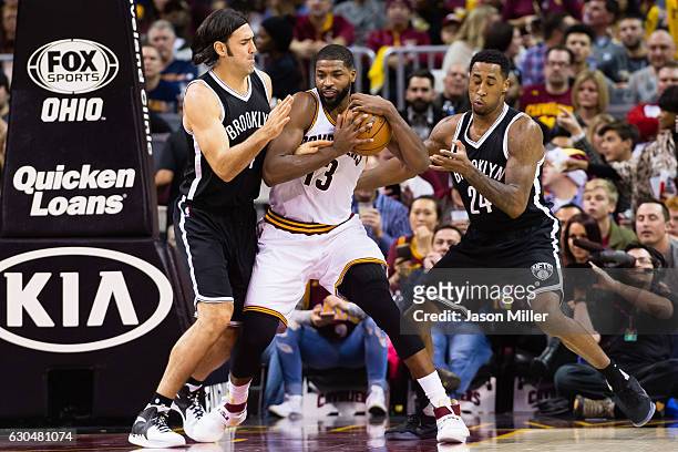 Luis Scola and Rondae Hollis-Jefferson of the Brooklyn Nets guard Tristan Thompson of the Cleveland Cavaliers during the second half at Quicken Loans...