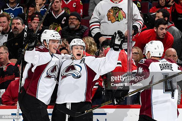 Nathan MacKinnon of the Colorado Avalanche reacts with Mikko Rantanen after scoring the game winning goal in overtime against the Chicago Blackhawks...