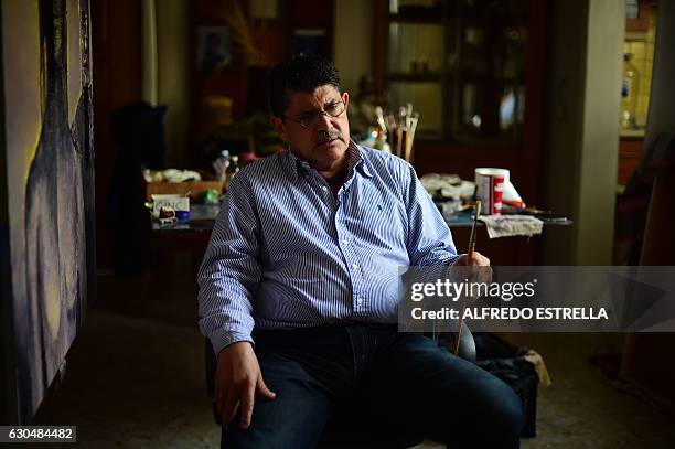 Javier Tejeda, a 64-year-old former Mexican federal police officer and ex-convict who became an artist in prison, speaks during an interview with AFP...