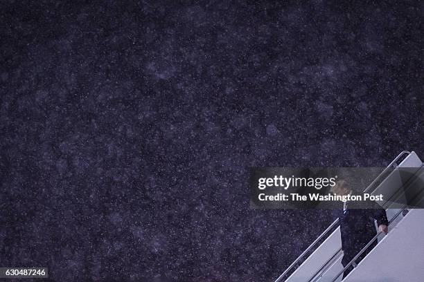 President-Elect Donald J. Trump disembarks his plane in the snow as he makes his way to a "USA Thank You Tour 2016" event at the DeltaPlex in Grand...