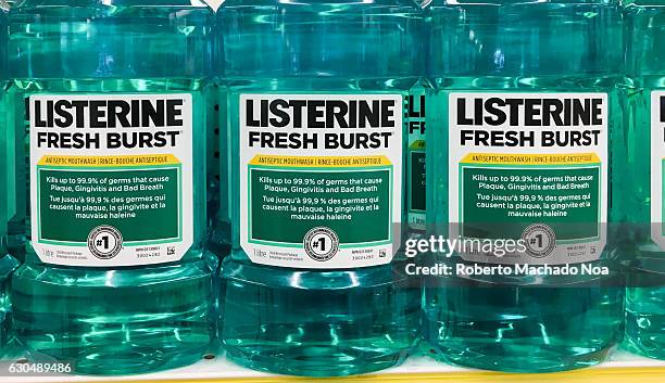 Close up of Listerine mouthwash bottles on display in a row. Label information clearly visible.