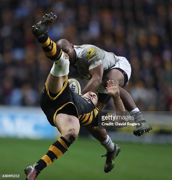 Jimmy Gopperth of Wasps falls as he is challenged by Aled Brew during the Aviva Premiership match between Wasps and Bath Rugby at The Ricoh Arena on...