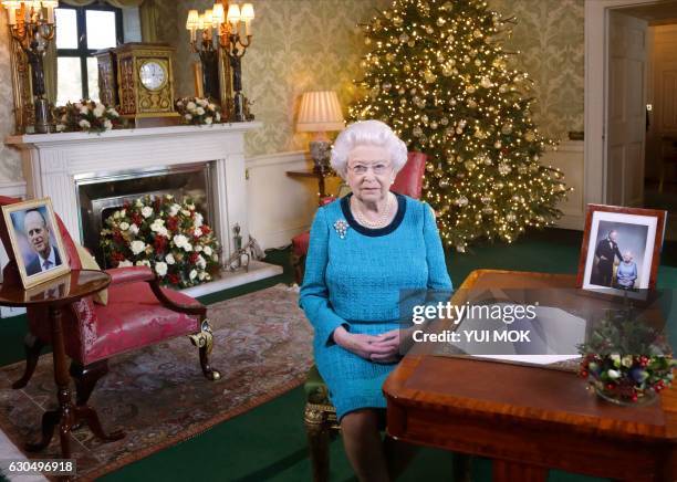 Britain's Queen Elizabeth II sits at a desk in the Regency Room in Buckingham Palace in London, after recording her Christmas Day broadcast to the...