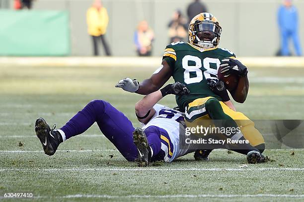 Ty Montgomery of the Green Bay Packers is brought down by Chad Greenway of the Minnesota Vikings during the first quarter of a game at Lambeau Field...