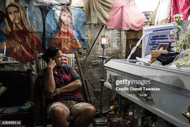 Kimberly Sailog watches over the coffin of her daughter, Christine Joy Sailog, 12 years old, on Christmas Eve December 24, 2016 in Laguna,...