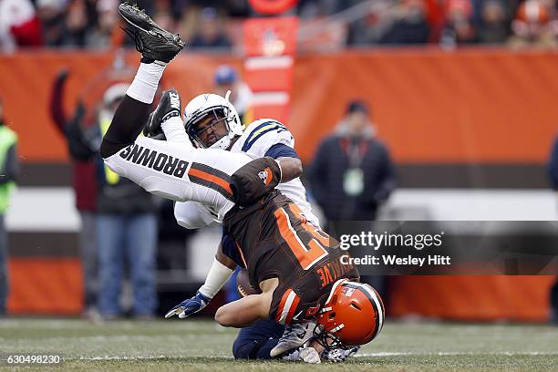 Darrell Stuckey of the San Diego Chargers tackles Seth DeValve of the Cleveland Browns at FirstEnergy Stadium on December 24, 2016 in Cleveland, Ohio.