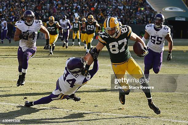 Jordy Nelson of the Green Bay Packers breaks a tackle by Andrew Sendejo of the Minnesota Vikings during the second quarter of a game at Lambeau Field...