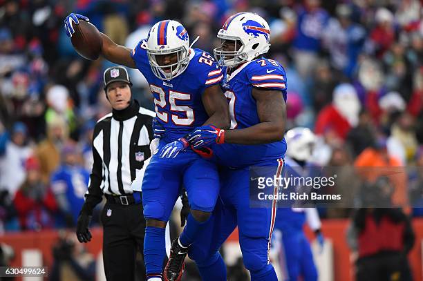 LeSean McCoy of the Buffalo Bills celebrates his touchdown with Jordan Mills of the Buffalo Bills against the Miami Dolphins during the second half...
