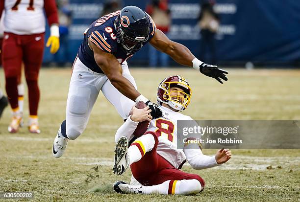 Quarterback Kirk Cousins of the Washington Redskins carries the football against Cornelius Washington of the Chicago Bears in the third quarter at...