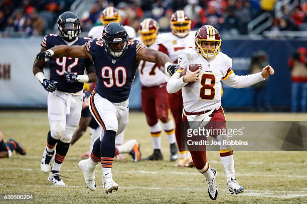Quarterback Kirk Cousins of the Washington Redskins carries the football against Cornelius Washington of the Chicago Bears in the third quarter at...